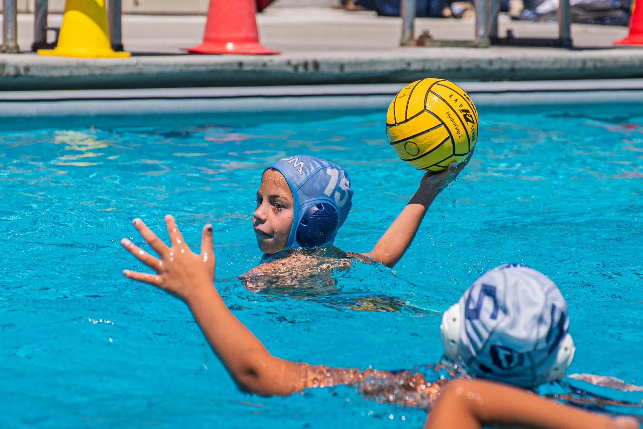 Young water polo player winds up to pass