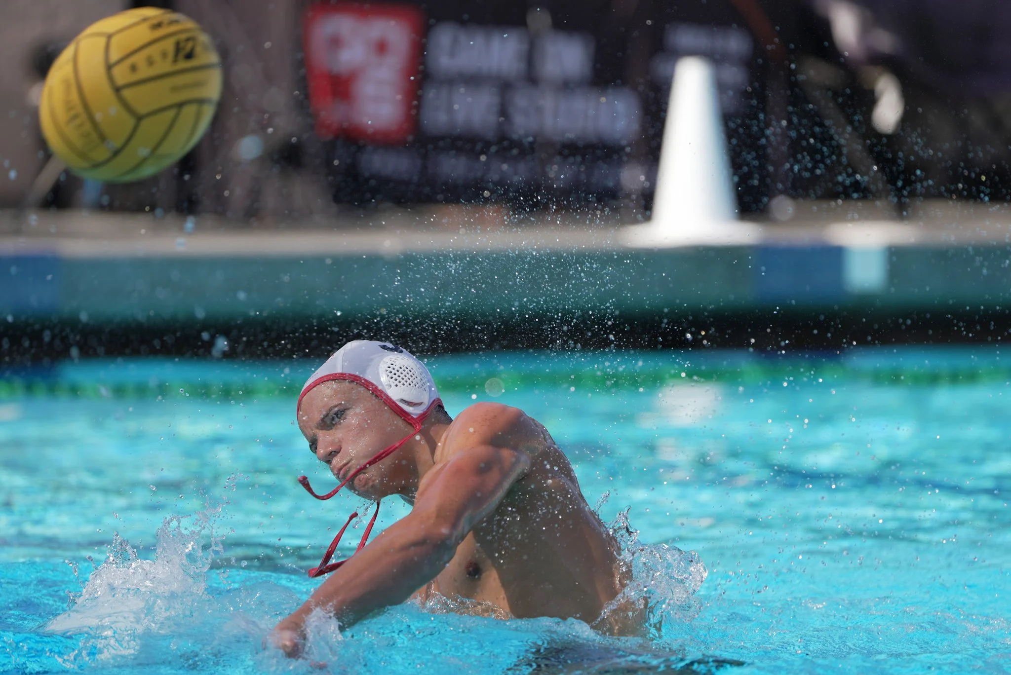 Two boys water polo players battle for position in front of goal